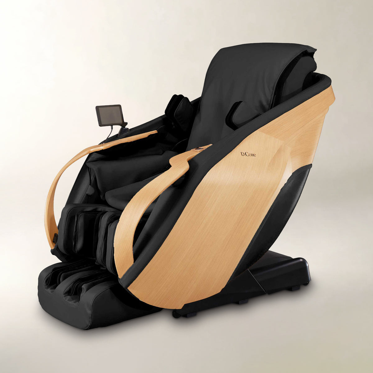A modern black and light wood massage chair with a small control screen, photographed on a clean light beige studio background.