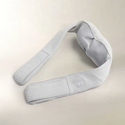 A light gray fabric neck and shoulder massage pillow with a breathable mesh backrest, shown on a neutral beige background.