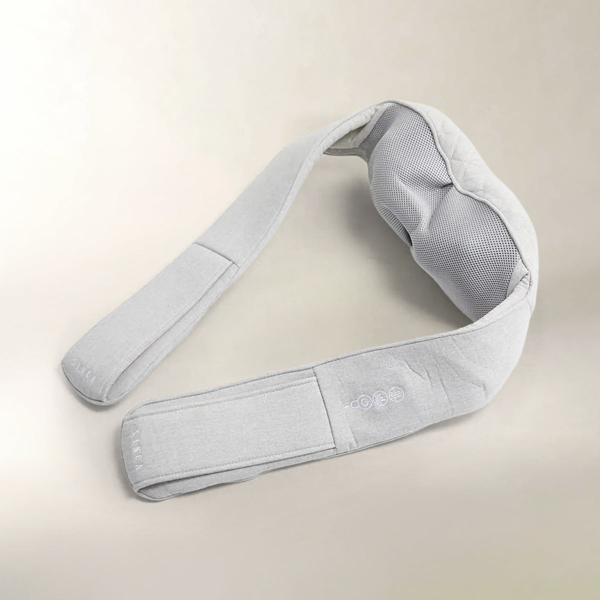 A light gray fabric neck and shoulder massage pillow with a breathable mesh backrest, shown on a neutral beige background.