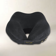 A black contoured neck pillow with a plush velvet-like fabric and a black elastic band featuring a gold 'Neck Sofa' logo patch, set against a plain light beige background.