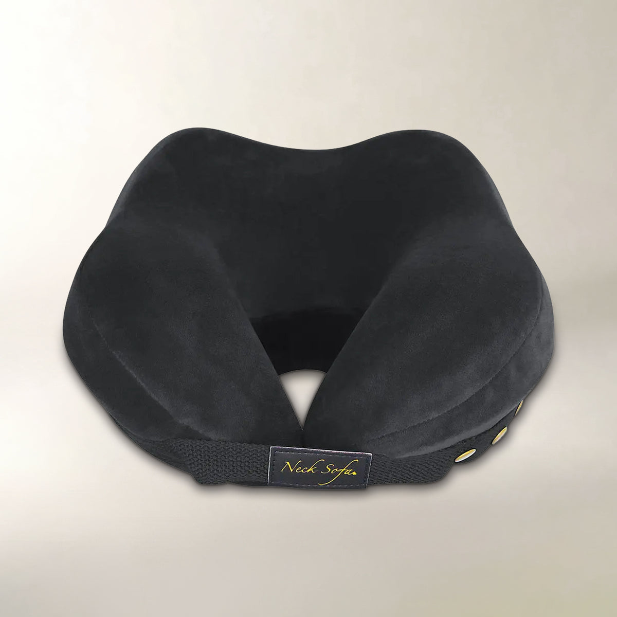 A black contoured neck pillow with a plush velvet-like fabric and a black elastic band featuring a gold 'Neck Sofa' logo patch, set against a plain light beige background.