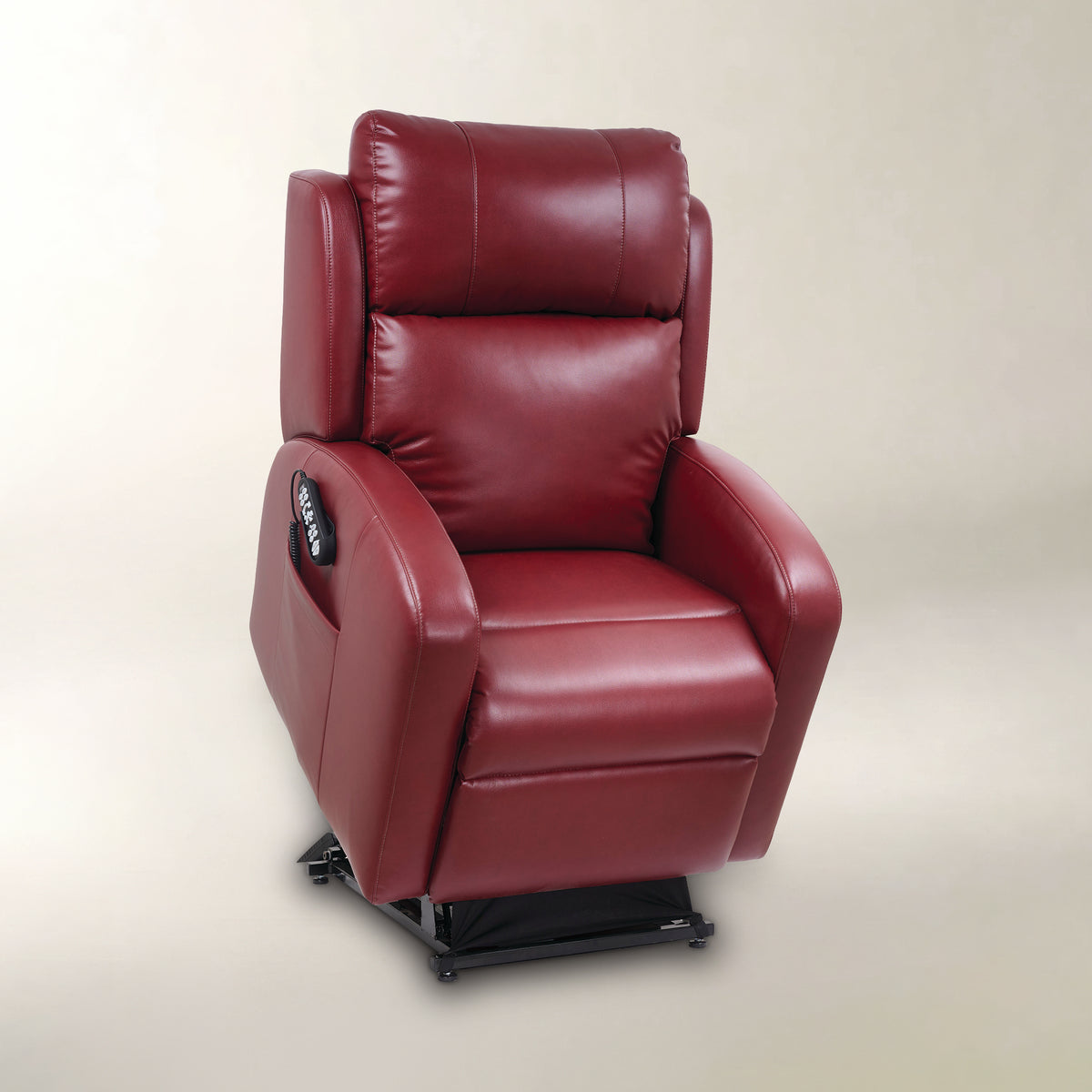 A red leather recliner chair with a black base and a side-mounted remote control, photographed against a neutral beige studio background.