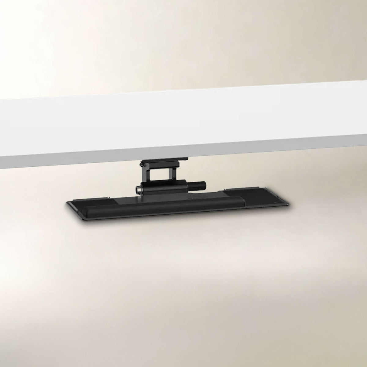 A black desk monitor arm mount shown from below, supporting a white monitor over a light beige surface.
