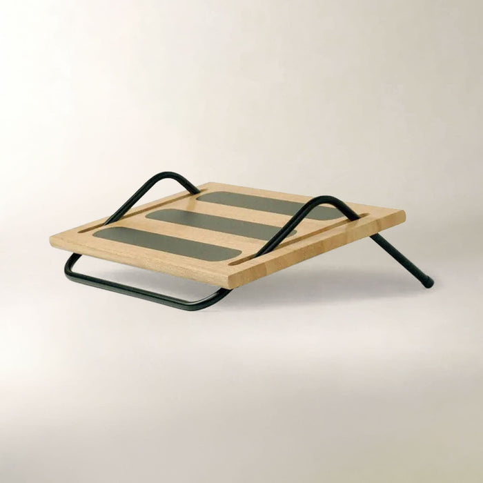A modern wooden desk riser with a light natural wood top, three dark green rectangular slats, and a black metal frame, shown on a neutral off-white background.