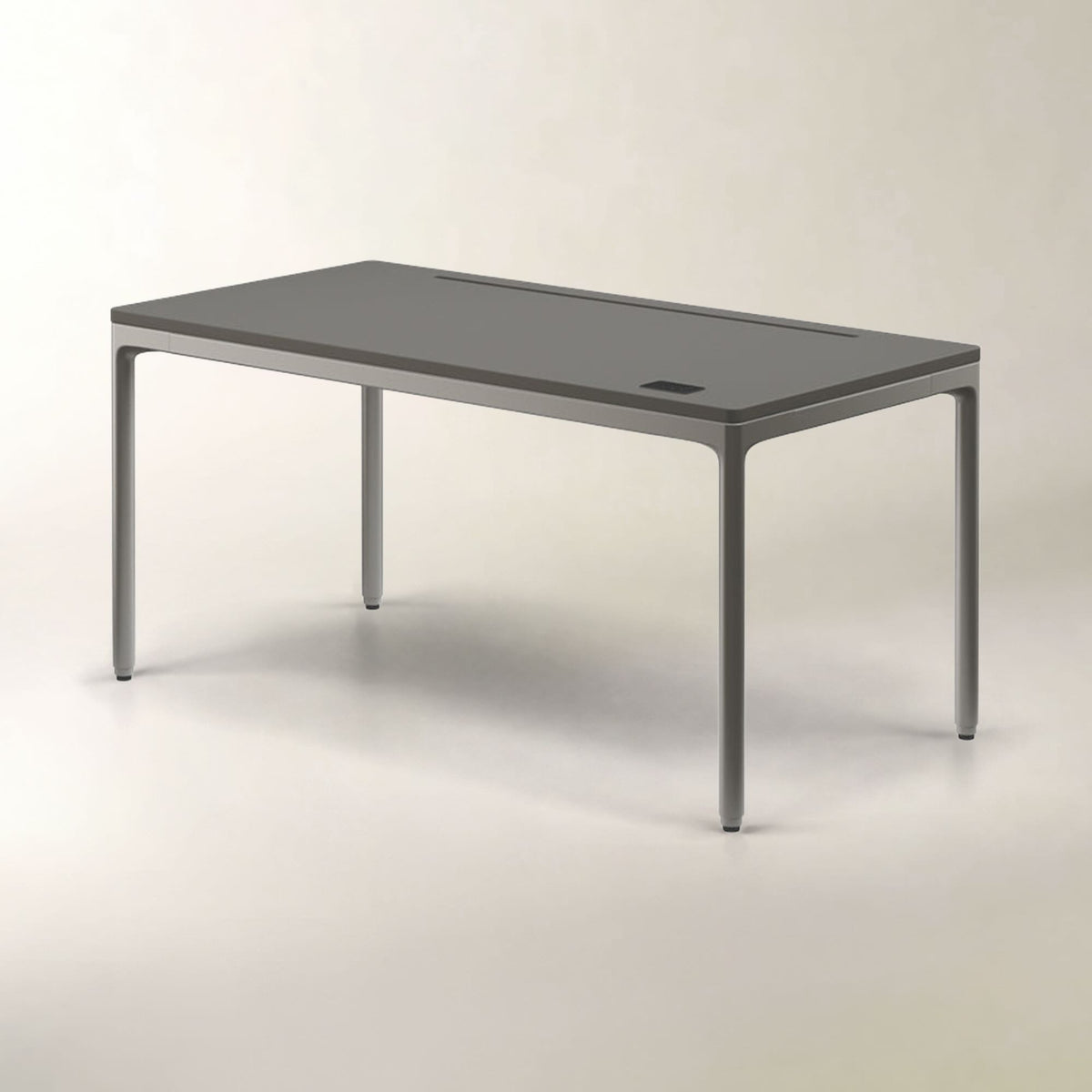 A modern rectangular table with a dark gray top and slim metallic legs, shown on a clean light gray studio background.