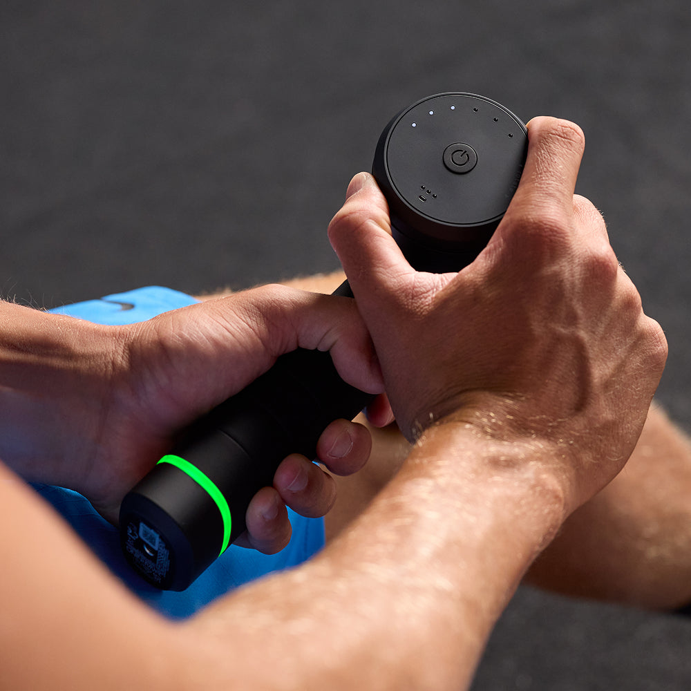 Person holding a Hypervolt 3 Pro Massager against a blurred background