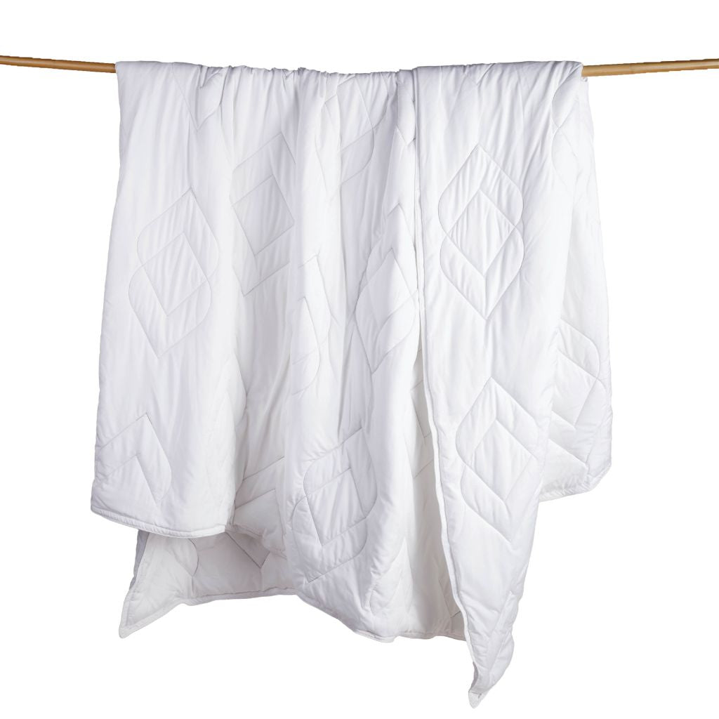 Duvet Insert + Cooling on a wooden rod against a white background