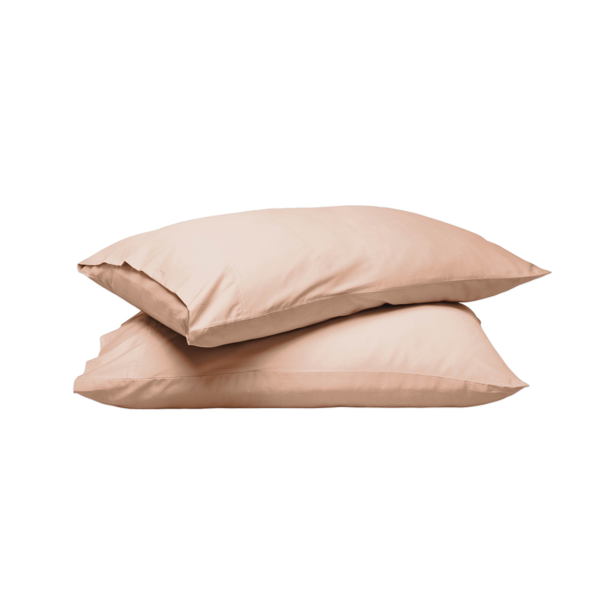 Two plain pillowcases stacked on a white background, in a soft warm beige or blush-tan tone.