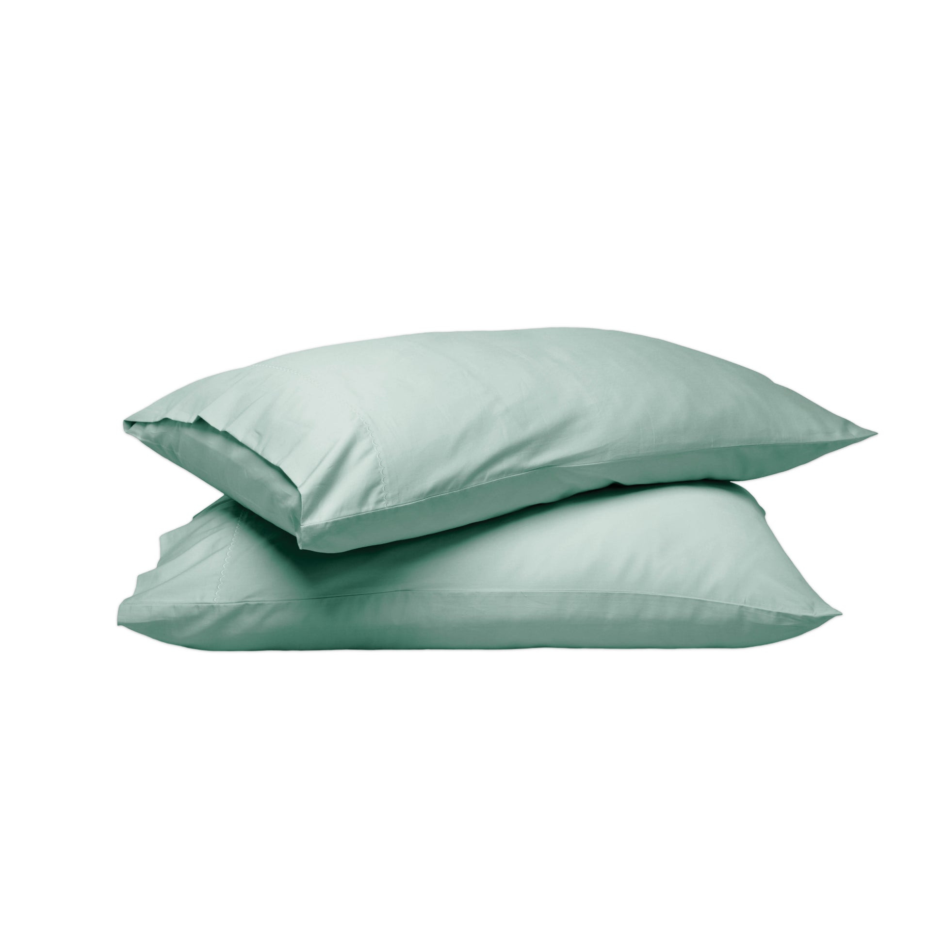Two mint green pillowcases stacked on a solid white background.