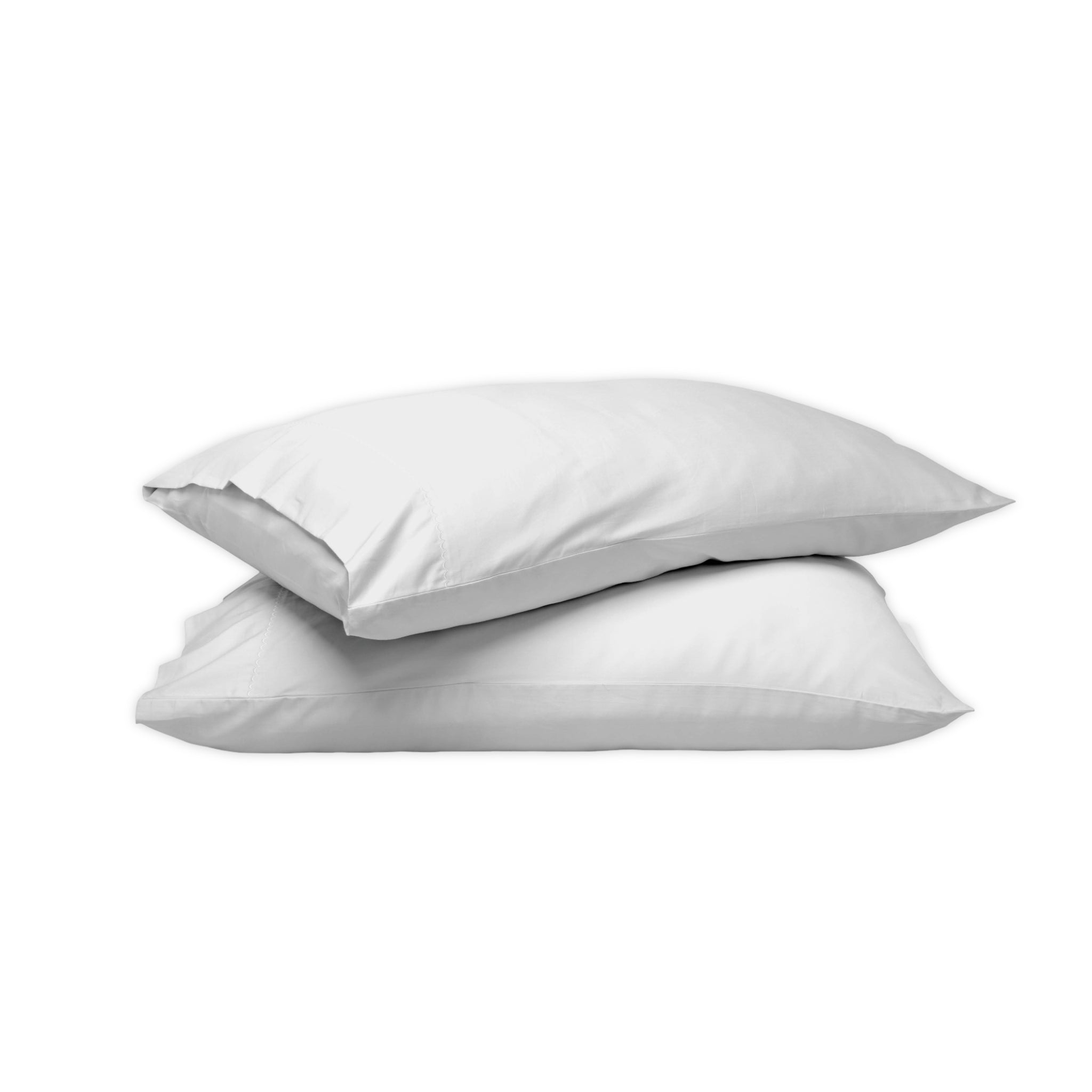 Two plain white pillows stacked on top of each other against a solid white background.