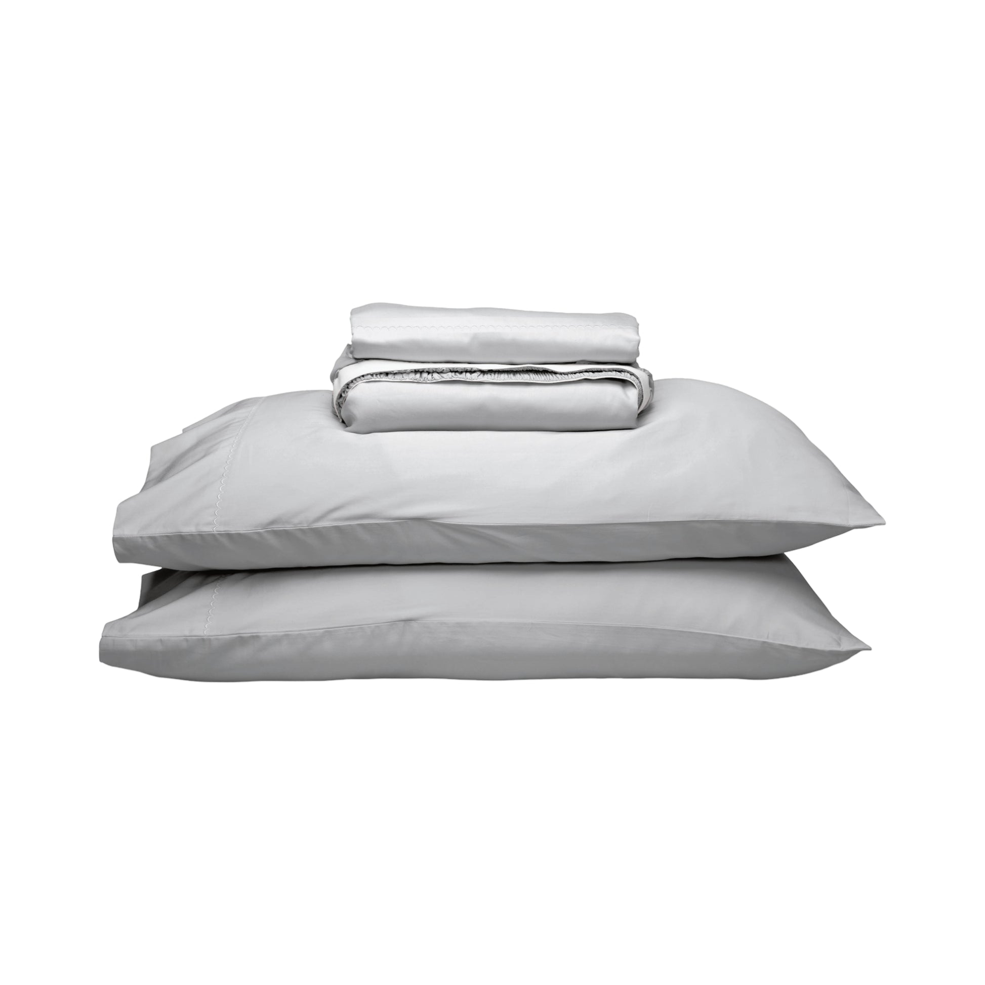 A stack of light gray bedding, including two pillows and a folded matching sheet, photographed on a plain white background.