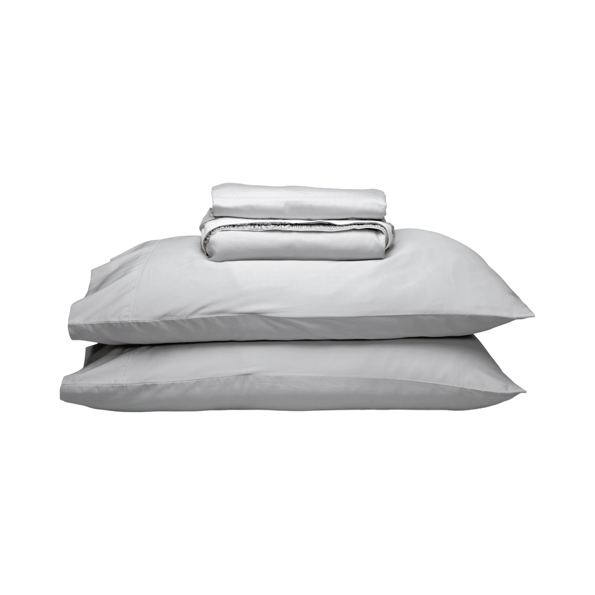 A stack of light gray bedding, including two pillows and a folded matching sheet, photographed on a plain white background.