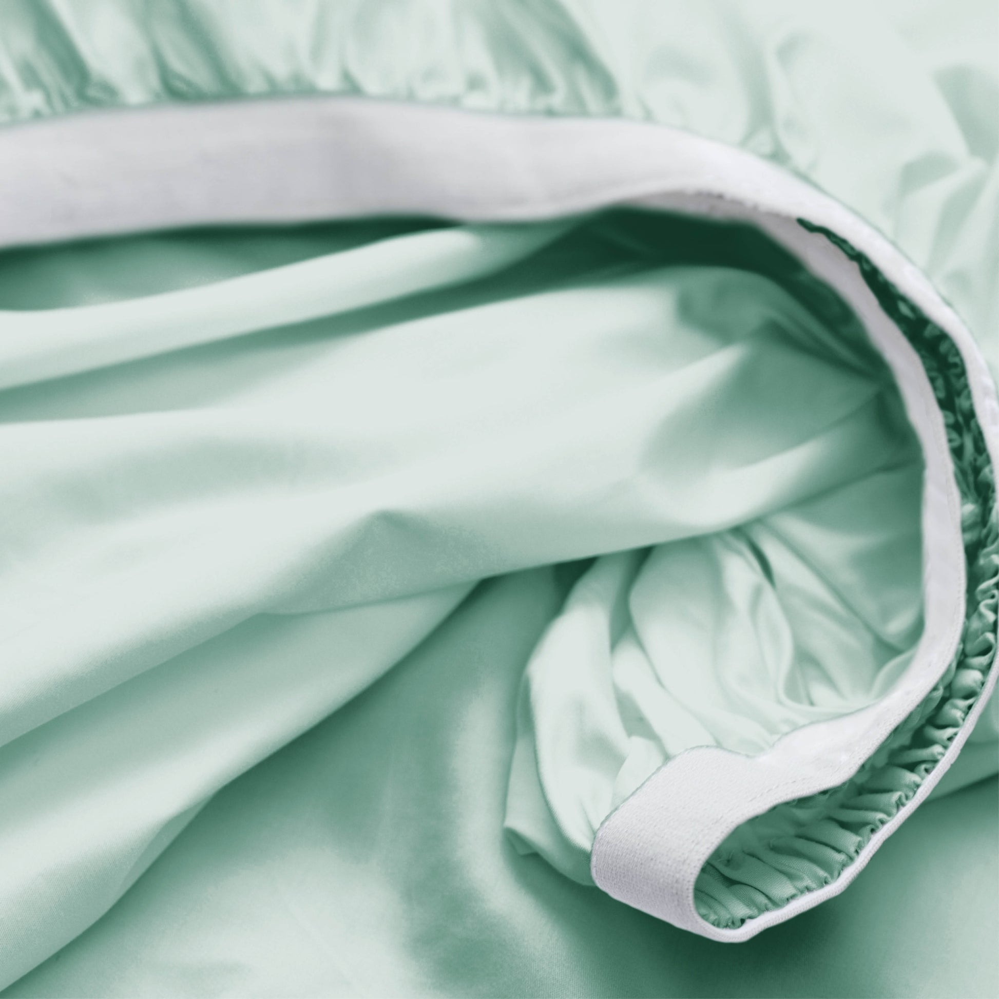 Close-up of light green fabric with white trim