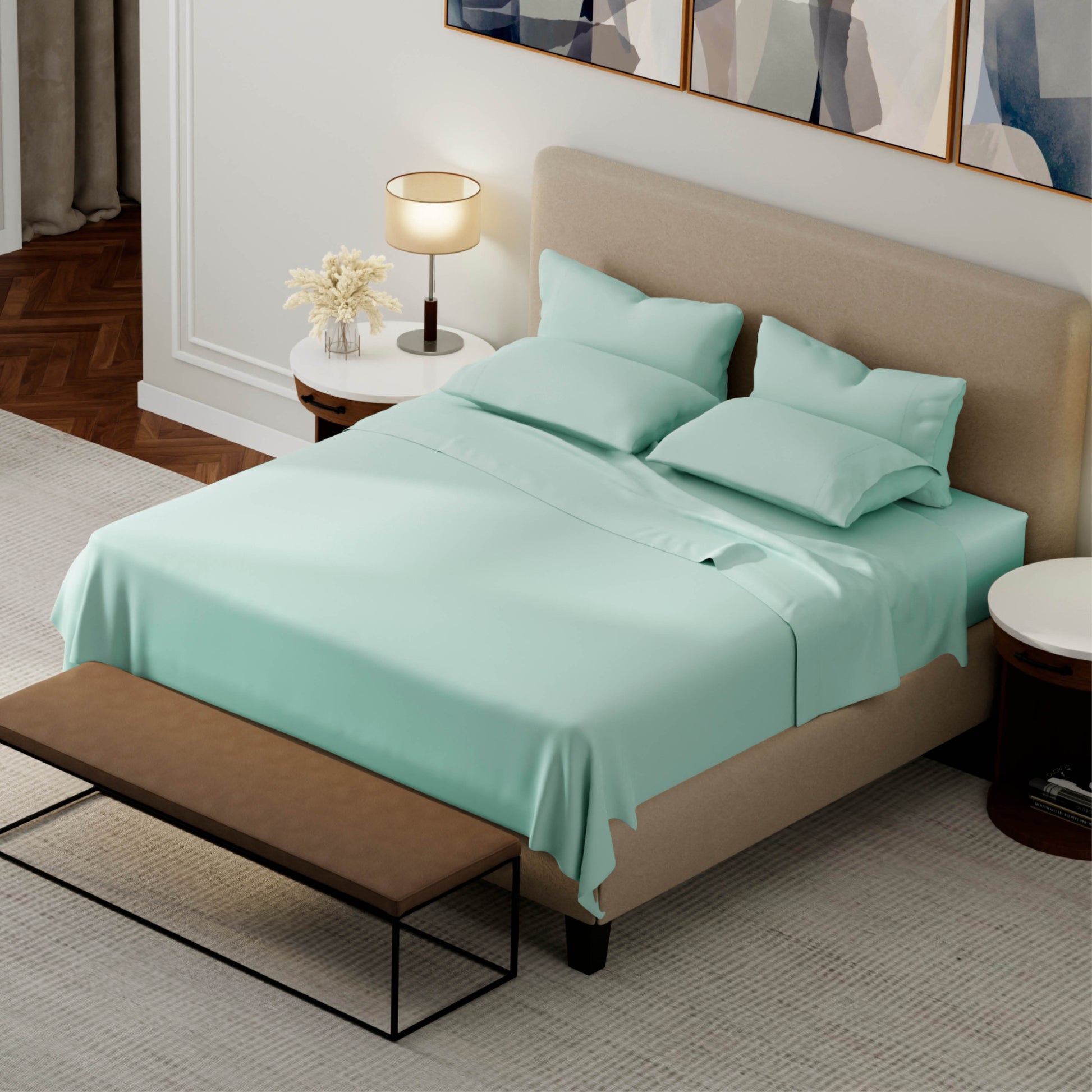 Teal bed sheets and pillows on a beige bed in a bedroom setting.