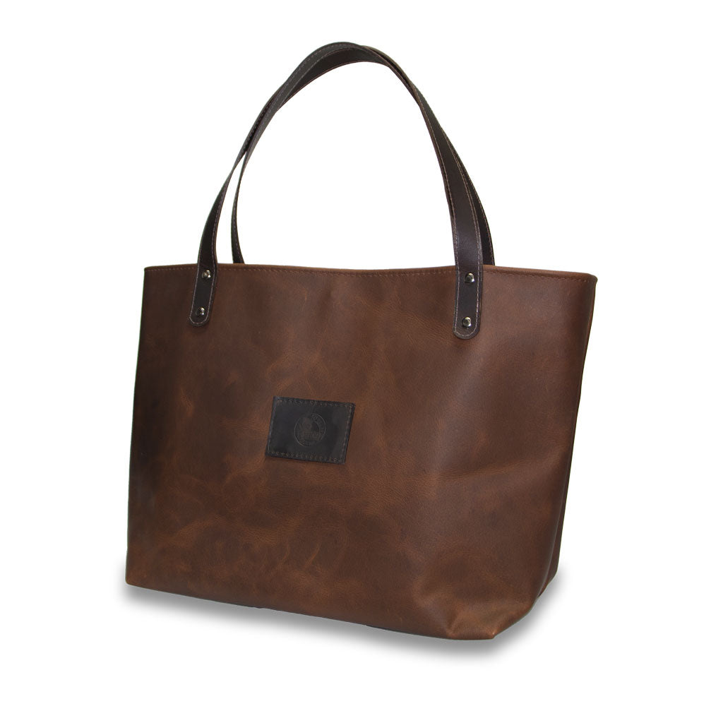 Brown leather tote bag with a visible brand logo on a white background