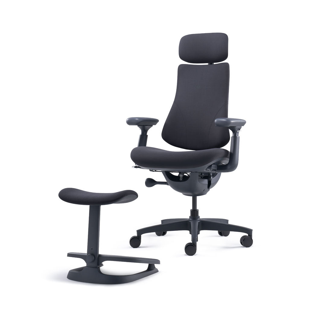 Black ergonomic office chair with headrest and footrest on a white background