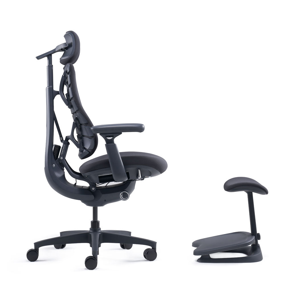 Black ergonomic office chair with armrests and footrest on a white background