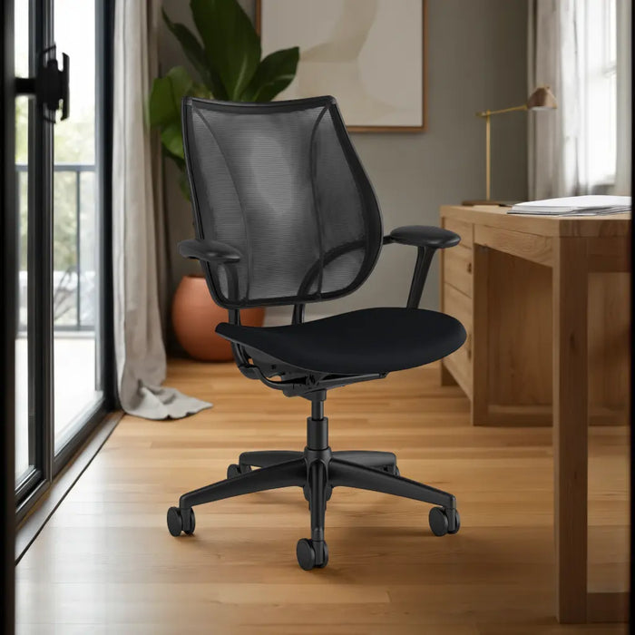 The Liberty Task Chair in black shown in a home office setting.