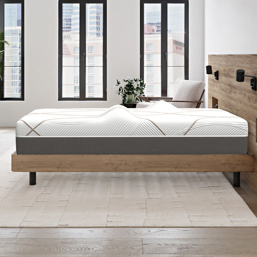 Side view of the GhostBed Massage 12" Hybrid Mattress on a platform wooden bed frame in a bedroom setting.