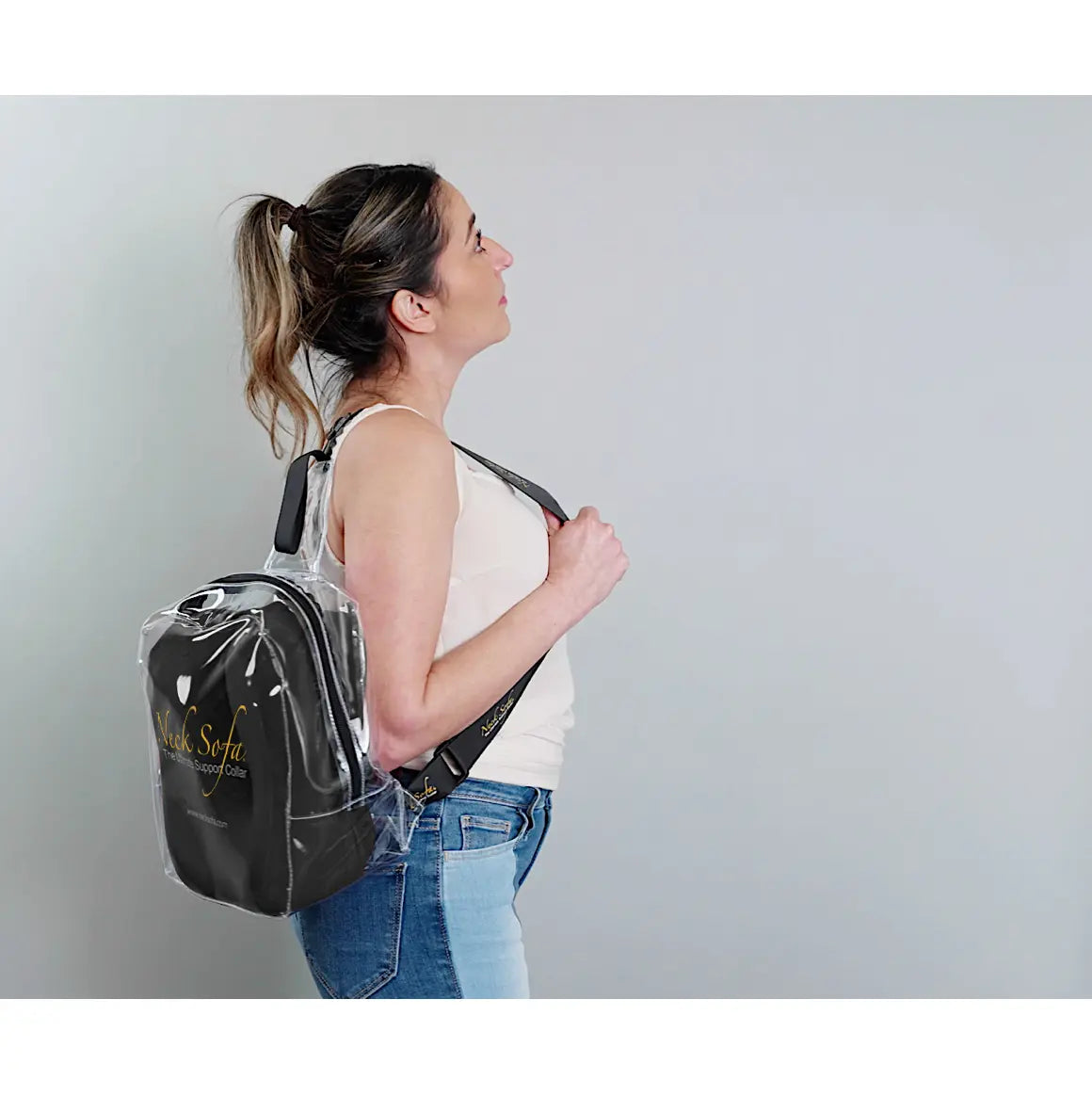 A woman wearing the Neck Sofa® Travel Neck Pillow in a clear bag.