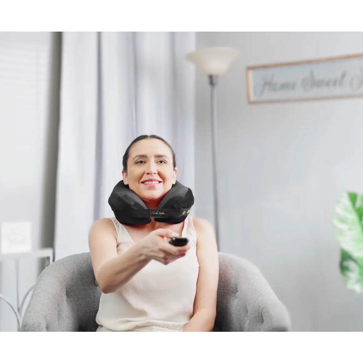 A woman wearing the Neck Sofa® Travel Neck Pillow.