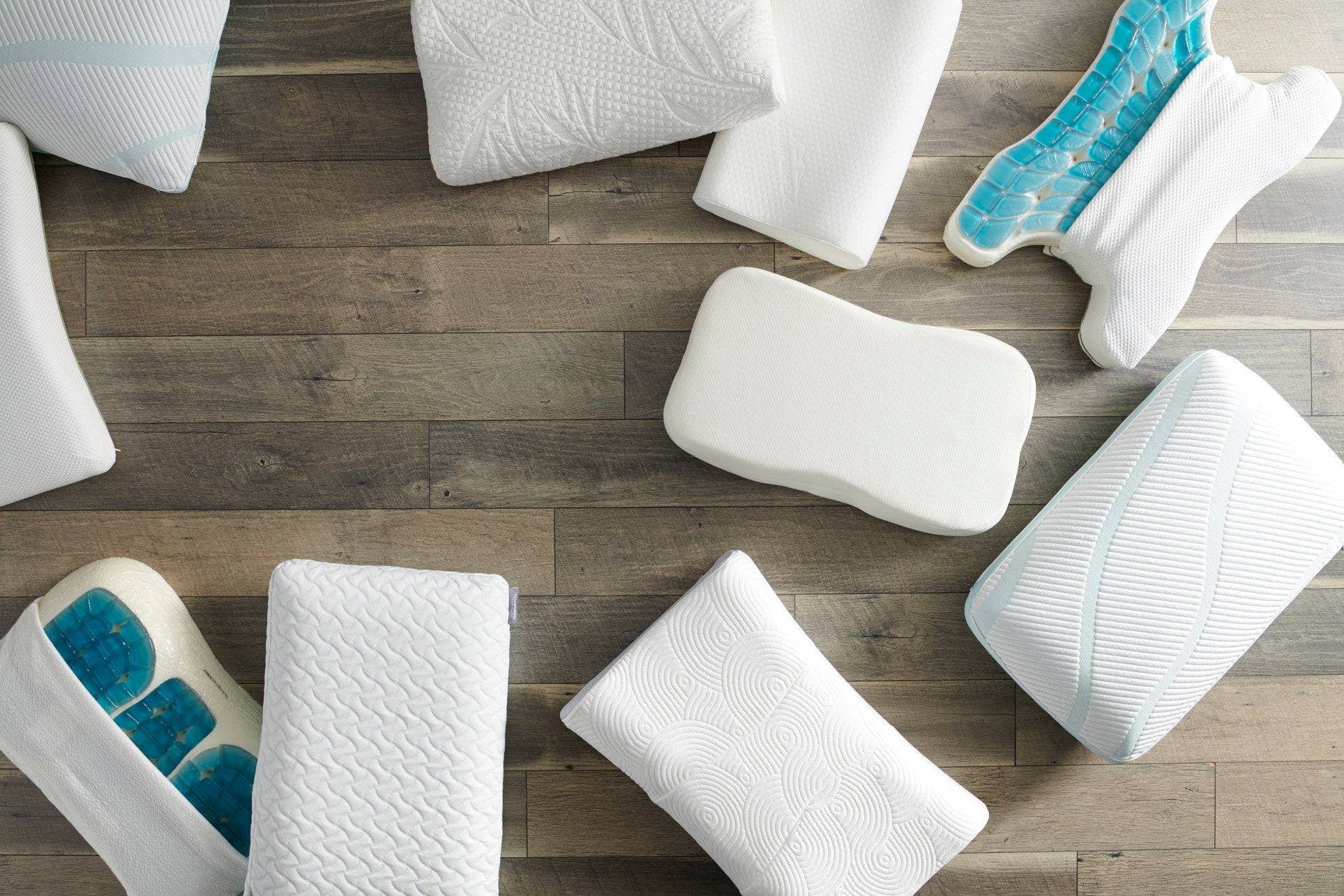 Various types of pillows on a wooden floor