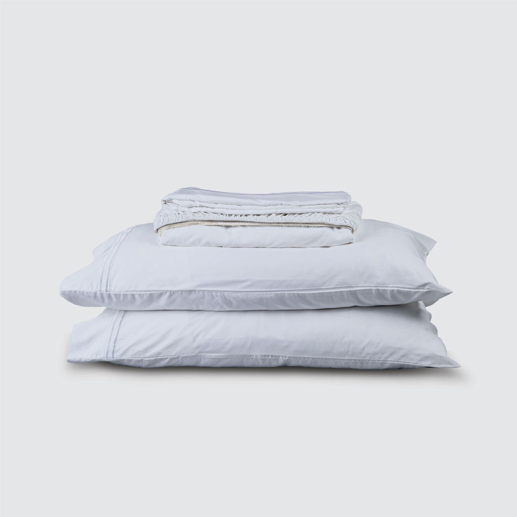 Stack of light blue bedding on a white background