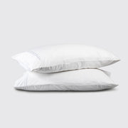 Two white pillows stacked on a light gray background