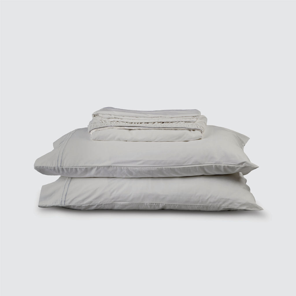 Stack of light gray bedding on a white background