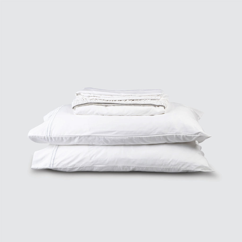 Two white pillows stacked on a light gray background