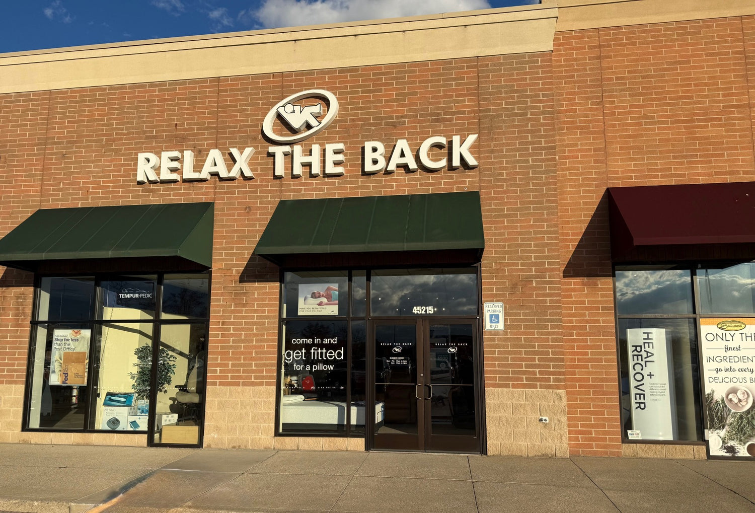 Storefront with 'Relax the Back' sign on a brick building