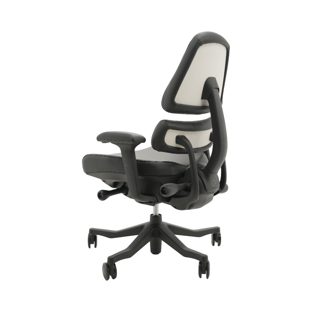 An ergonomic office chair with a high back, adjustable armrests, and a four-wheel base, shown from a rear angle on a white background.