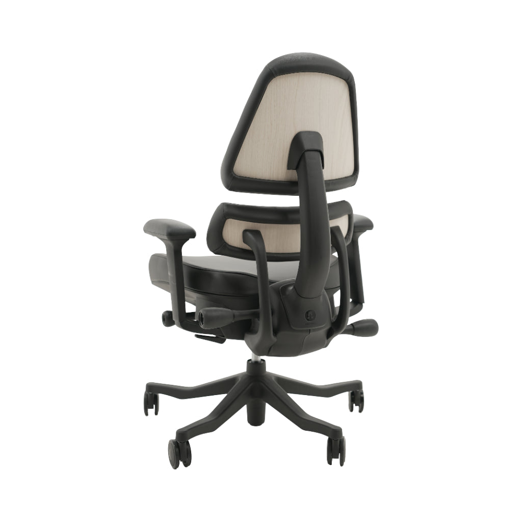 An ergonomic office chair with a high back, adjustable armrests, and a four-wheel base, shown from a rear angle on a white background.