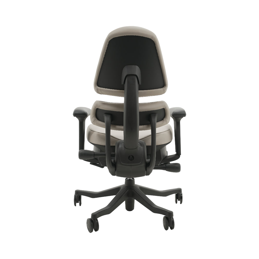 An ergonomic office chair with a high back, adjustable armrests, and a four-wheel base, shown from a rear angle on a white background.