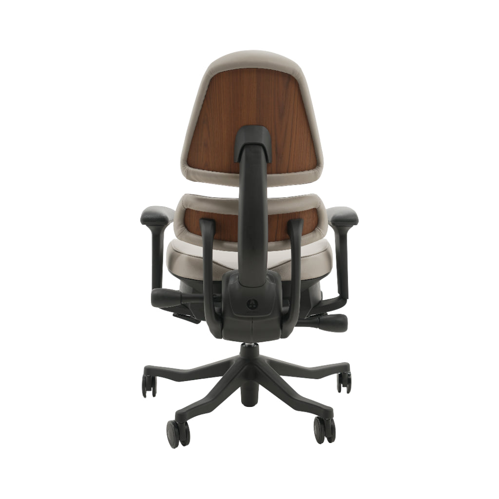 An ergonomic office chair with a high back, adjustable armrests, and a four-wheel base, shown from a rear angle on a white background.