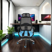 A black and blue ergonomic gaming chair with a mesh backrest, headrest, and padded seat sits in a modern workspace with dual monitors and ambient LED lighting.