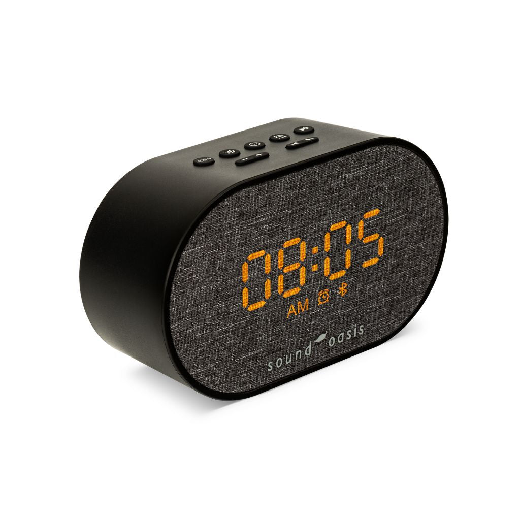 A black oval-shaped Sound Oasis digital alarm clock with a textured gray fabric front panel and bright orange LED display showing 08:05 AM.