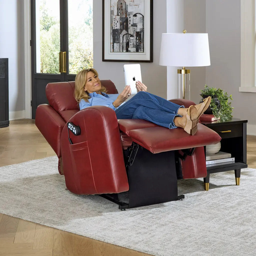 Woman relaxing in a red recliner chair in a living room.