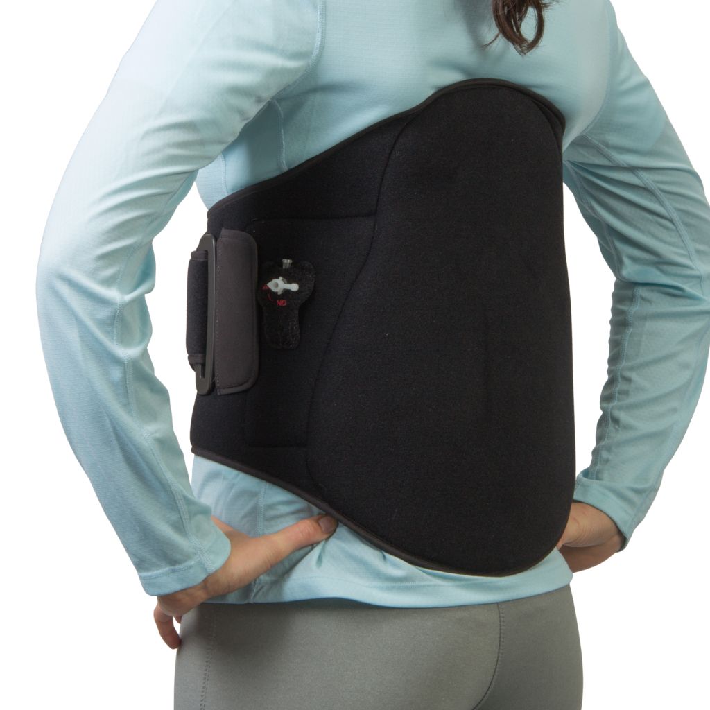 A person wearing a black high back support brace over a light blue long-sleeve top and gray pants, shown from the back against a white background.