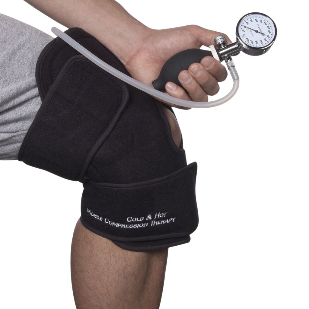 A person's hand and knee are shown wearing a black knee wrap with a hand pump and gauge attached, on a plain white background.