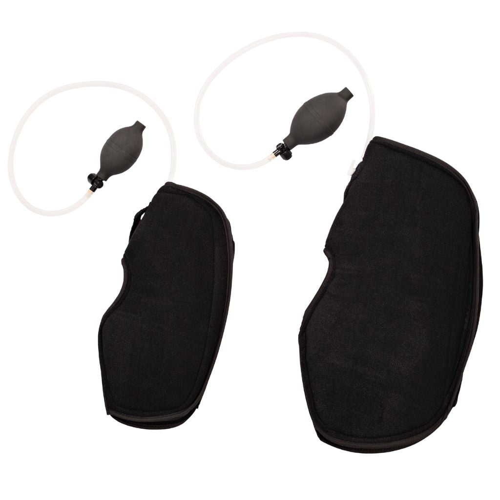 Two black knee suppports shown with small black pump bulb and clear tubing, photographed on a plain white background.