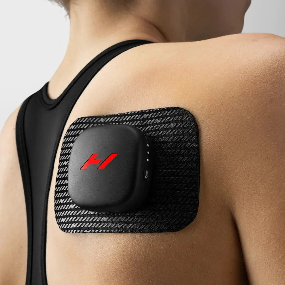 A woman using the Venom Go Portable Heat and Vibration Patch on her shoulder.