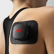 A woman using the Venom Go Portable Heat and Vibration Patch on her shoulder.