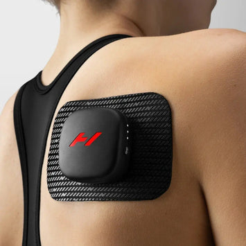 A woman using the Venom Go Portable Heat and Vibration Patch on her shoulder.