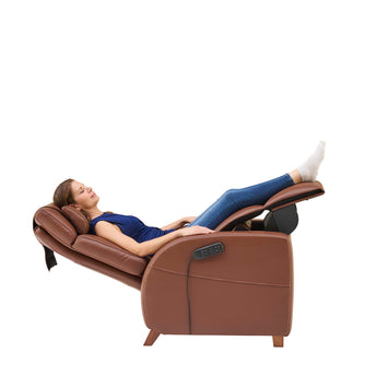 A woman laying on the Vesta recliner in the elevated position.