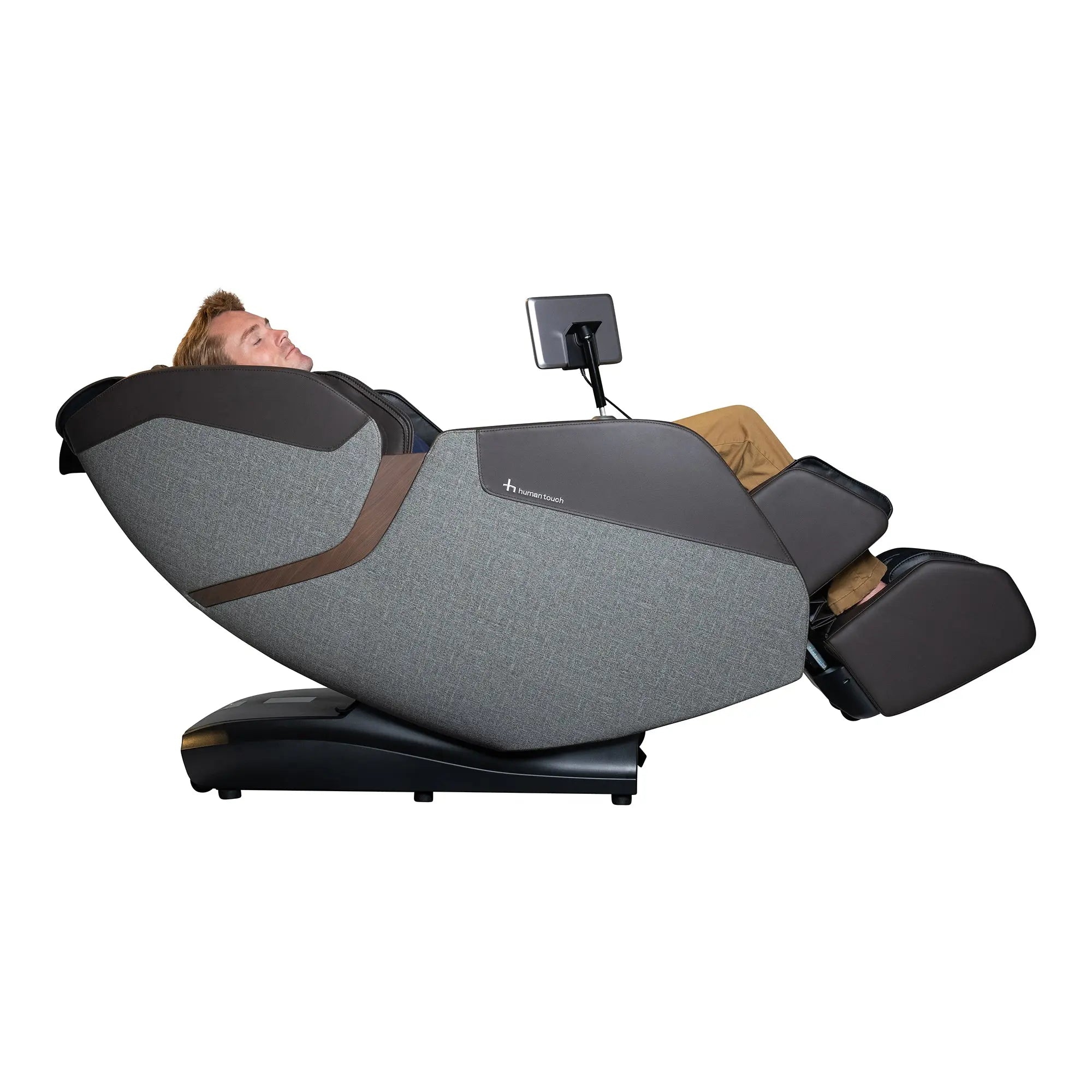 A man using the WholeBody® ROVE Massage Chair by Human Touch® on a white background with the calf and foot massager down