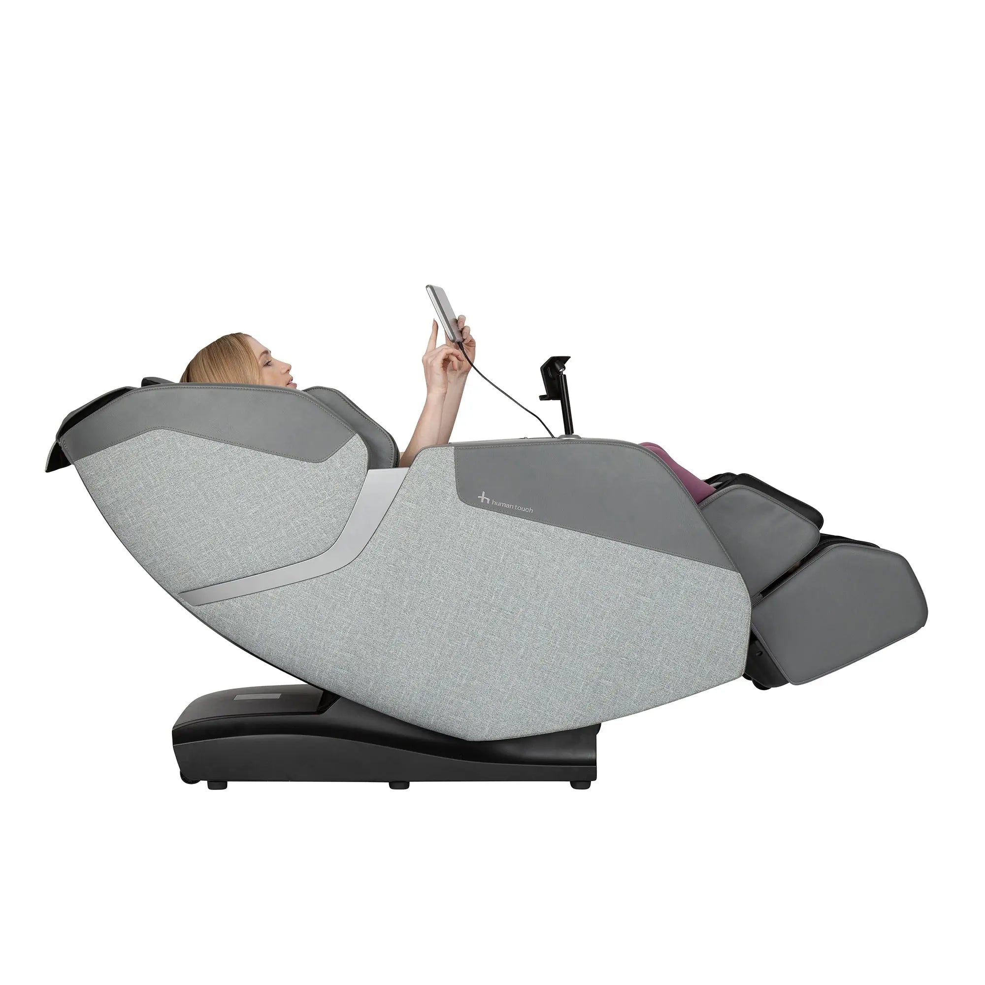 A woman using the WholeBody® ROVE Massage Chair by Human Touch® on a white background with the calf and foot massager down