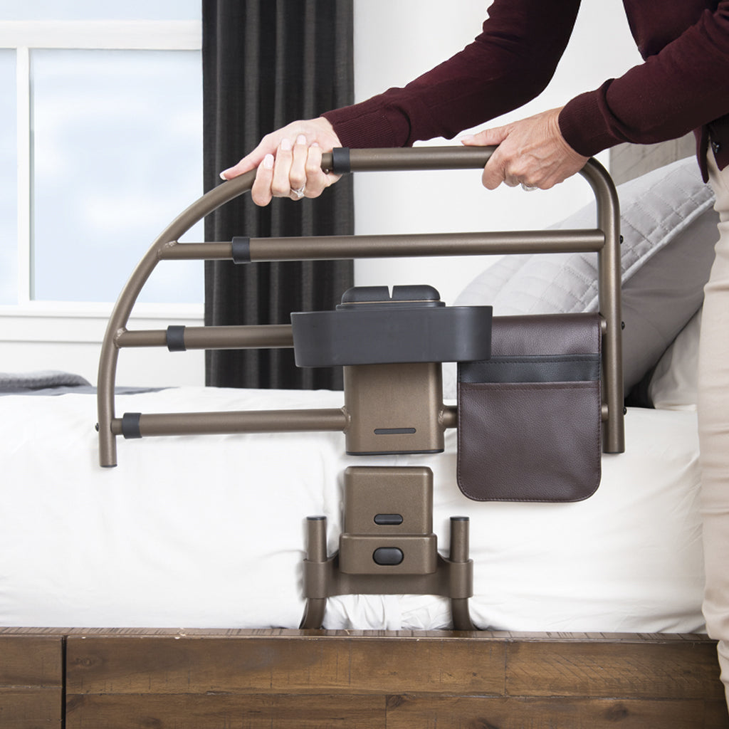 Person using a bed rail to assist with getting in or out of bed.