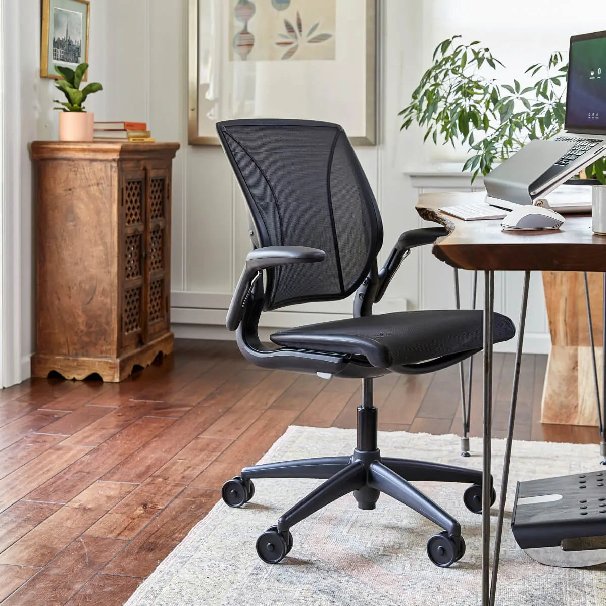Black office chair in a home office setting with a desk and decor.