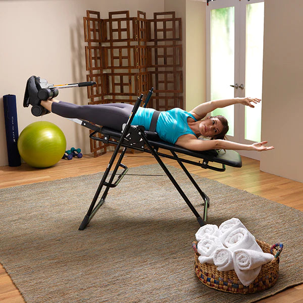Women's entire body reclined back using the Mastercare Back-A-Traction Inversion Table